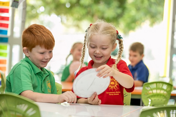 two students working on a project at a desk