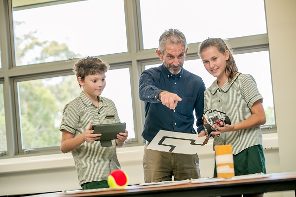 students using technology with teacher